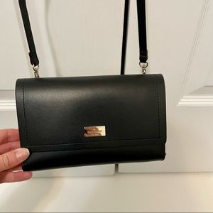 Black Kate Spade satchel wallet with bright pink inside